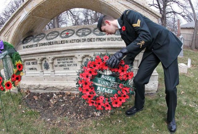 Remembrance Sunday, Cpl. Kyle Hall lays a wreath at the RWR Memorial, St. John's Cathedral Churchyard